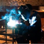 man-with-mask-welding-metal-atelier